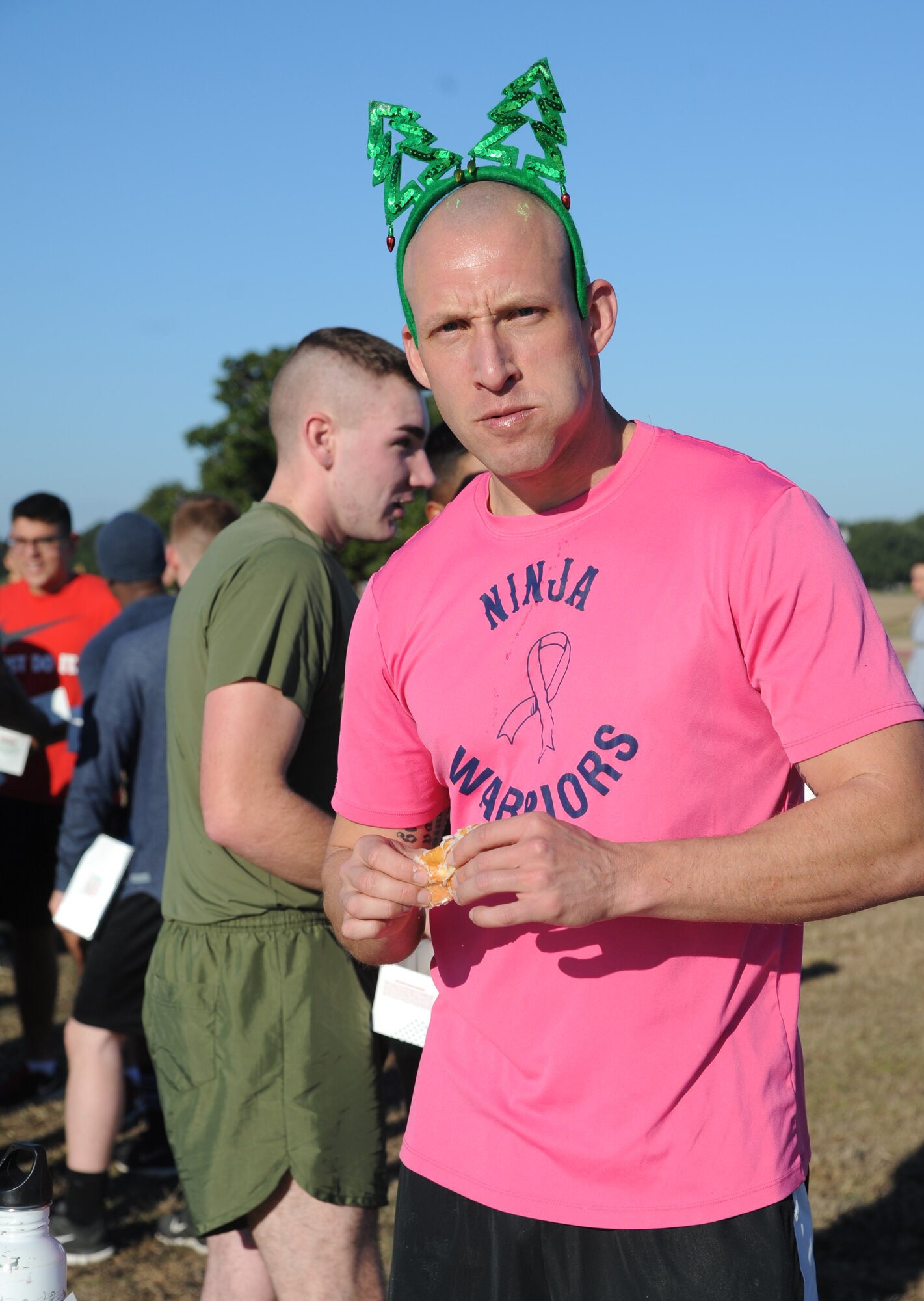Staff Sgt. Matthew Petitgout, Keesler Marine Detachment instructor, eats a donut during a U.S. Marine Corps "Toys for Tots" Foundation fundraising event Dec. 13, 2014, at Keesler Air Force Base, Miss.  Approximately 160 Marines participated in the event, and more than 180 toys were collected for the community outreach event benefiting the Marine Corps "Toys for Tots" campaign. (U.S. Air Force photo by Kemberly Groue)