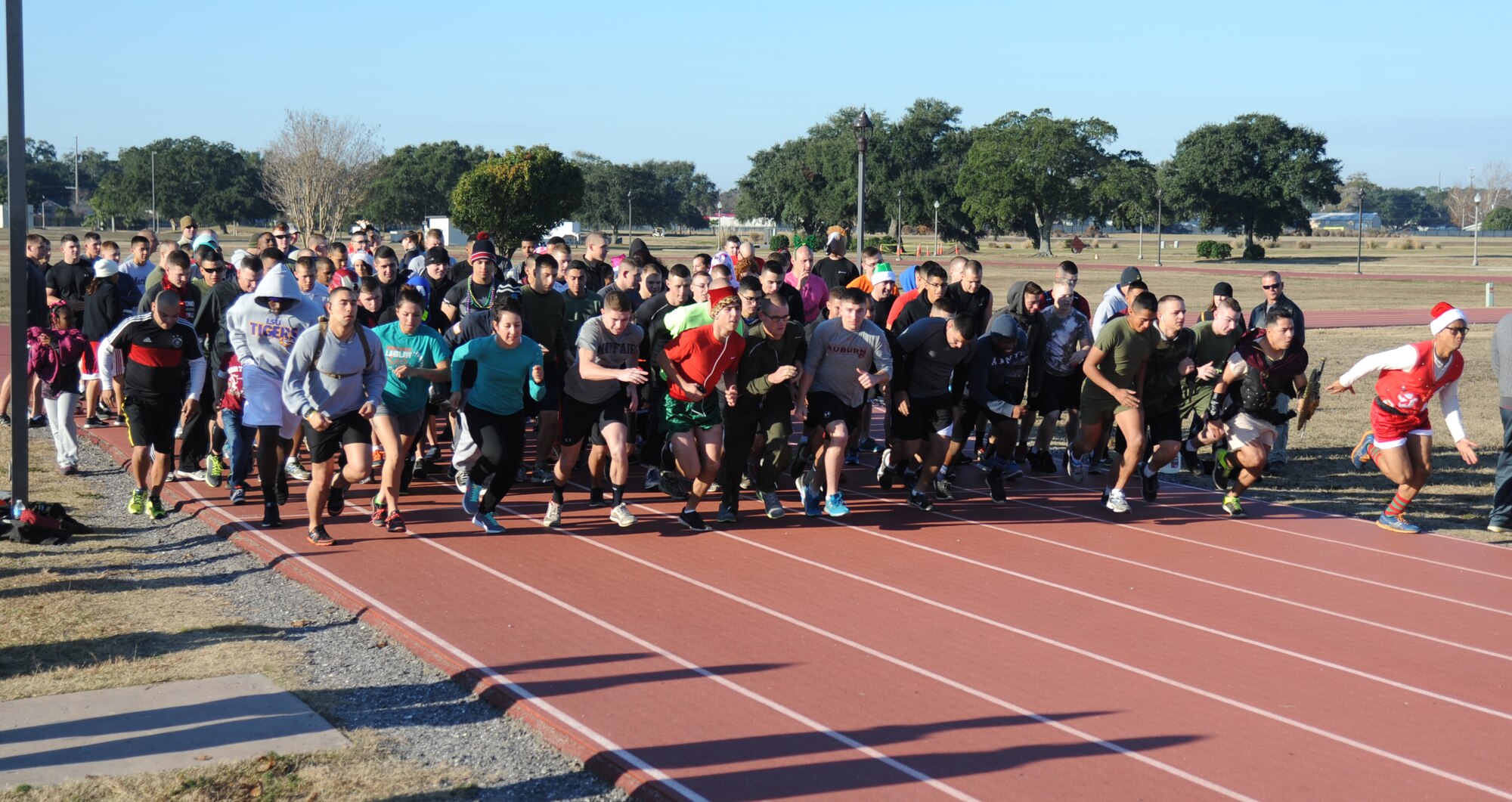 Approximately 160 Marines from the Keesler Marine Detachment begin a lap around the Triangle Track during a U.S. Marine Corps "Toys for Tots" Foundation fundraising event Dec. 13, 2014, at Keesler Air Force Base, Miss. More than 180 toys were collected for the community outreach event benefiting the Marine Corps "Toys for Tots" campaign. (U.S. Air Force photo by Kemberly Groue)