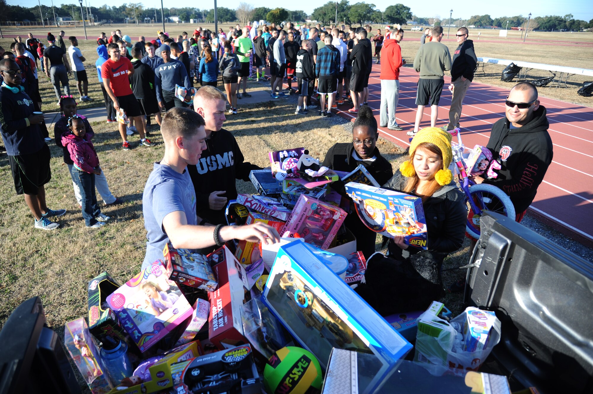 Members from the Keesler Marine Detachment load toys in the back of a truck during a U.S. Marine Corps "Toys for Tots" Foundation fundraising event Dec. 13, 2014, at Keesler Air Force Base, Miss.  Approximately 160 Marines participated in the event, and more than 180 toys were collected for the community outreach event benefiting the Marine Corps "Toys for Tots" campaign. (U.S. Air Force photo by Kemberly Groue)