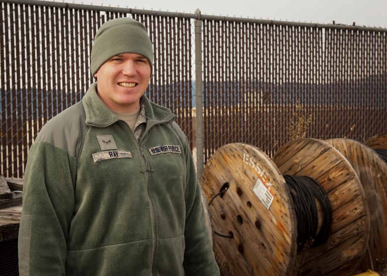 PETERSON AIR FORCE BASE, Colo. – Airman 1st Class Nicholas Ray, 21st Communications Squadron cable and antenna maintenance technician, stands in front of several rolls of fiber optic cable in the cable yard Dec. 8, 2014. Ray and his team climb towers to install antennas and work in manholes to make sure connections aren’t causing interference in communication and are safe. They make sure everyone on base is online and connected to accomplish the mission. (U.S. Air Force photo by Airman 1st Class Rose Gudex)