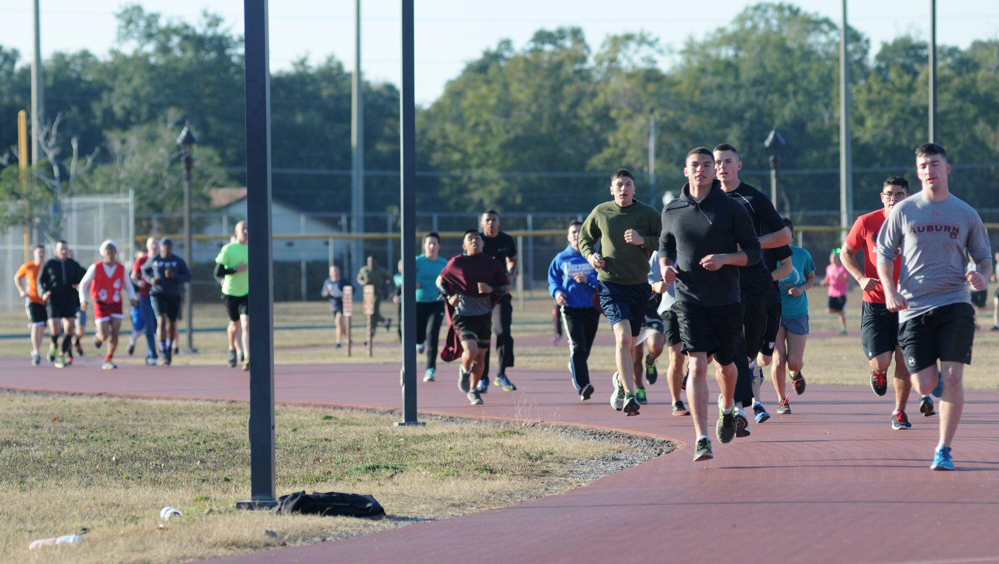 Approximately 160 Marines from the Keesler Marine Detachment complete a lap around the Triangle Track during a U.S. Marine Corps "Toys for Tots" Foundation fundraising event Dec. 13, 2014, at Keesler Air Force Base, Miss. More than 180 toys were collected for the community outreach event benefiting the Marine Corps "Toys for Tots" campaign. (U.S. Air Force photo by Kemberly Groue)