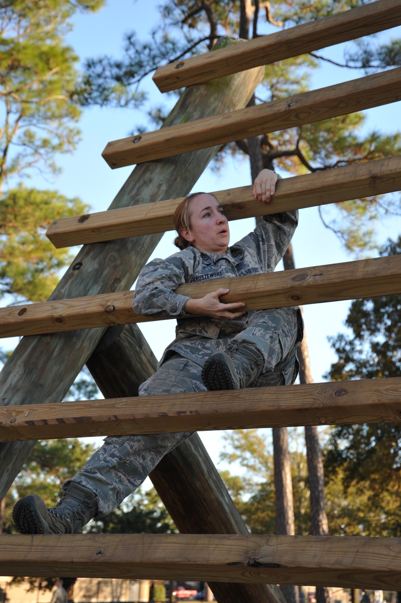 1st Lt. Elizabeth Kruszewski, a clinical nurse and the infection control monitor with the 927th Aeromedical Staging Squadron from Tampa Florida, negotiates the "reverse climb" obstacle course during the Junior Officer Leadership Development Course at Keesler Air Force Base, Mississippi. (U.S. Air Force photo/Maj. Marnee Losurdo)