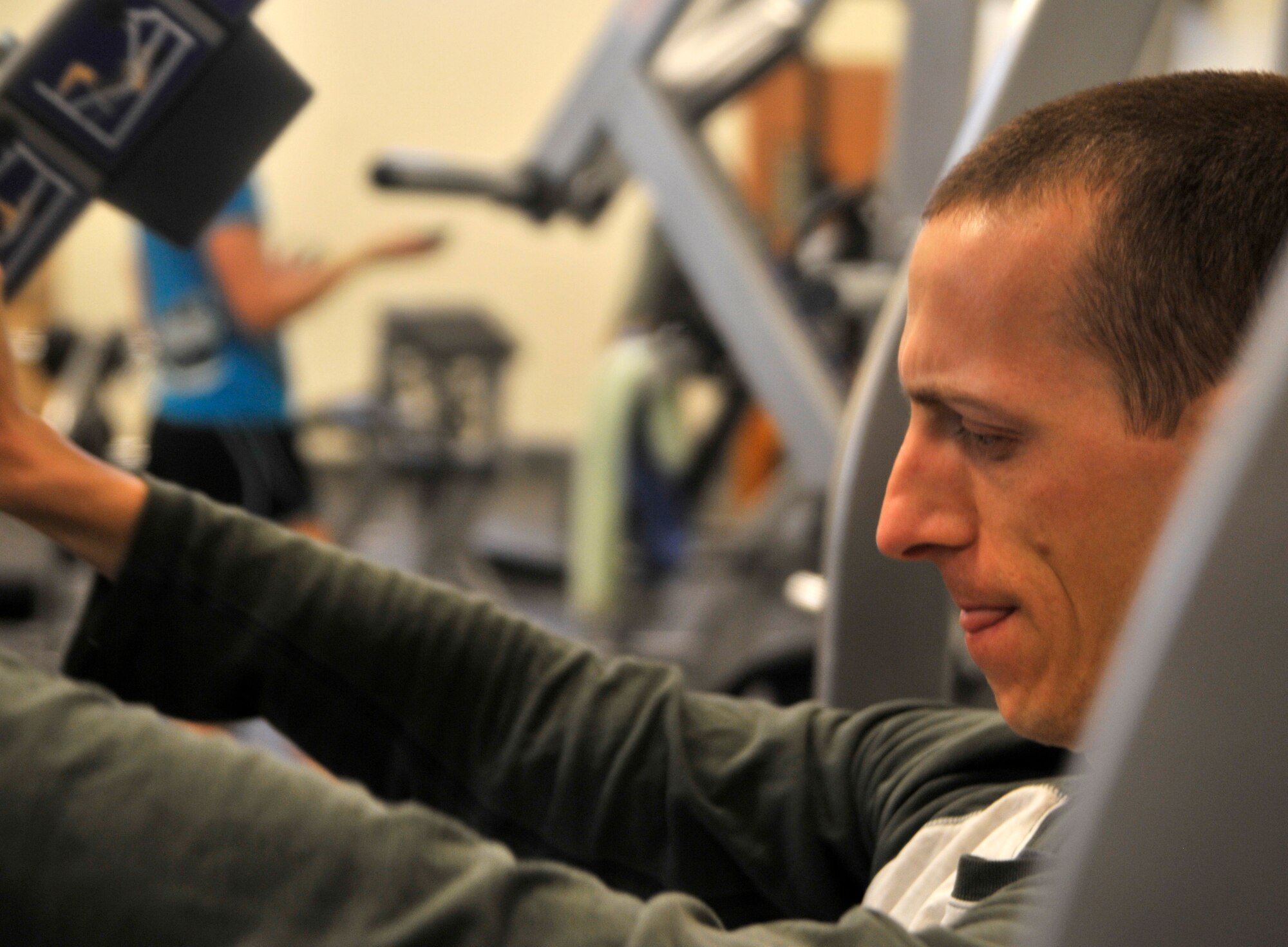 2nd Lt. Joel, 11th Reconnaissance Squadron intelligence instructor, takes advantage of the new Predator Fitness Center equipment and performs incline bench presses on an assisted lifting machine Dec. 11, 2014, at Creech Air Force Base, Nevada. The assisted lifting machines were one of the most requested items for the Predator Fitness Center prior to the center’s renovation Dec. 4-5, 2014. The new equipment now provides the Creech Medical Aid Station the opportunity to provide better physical therapy services than before. (U.S. Air Force photo by Airman 1st Class Christian Clausen/Released)(Last names withheld for security purposes)