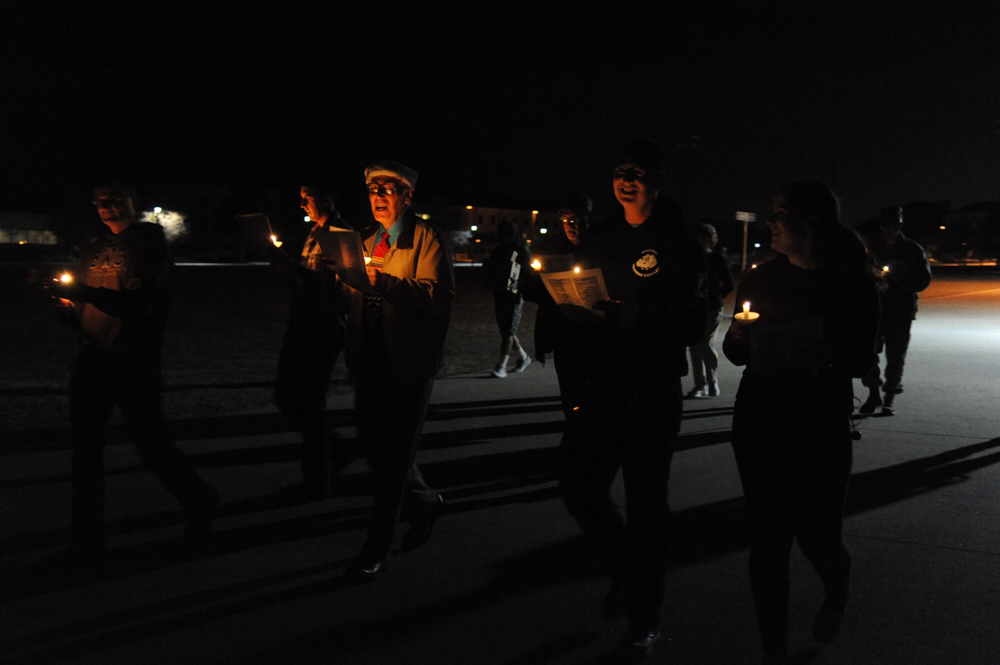 Keesler personnel make their way around the Triangle Courtyard singing Christmas carols Dec. 12, 2014, at Keesler Air Force Base, Miss.  Following the Christmas caroling, hot chocolate and cookies were available to everyone in attendance.  (U.S. Air Force photo by Kemberly Groue)