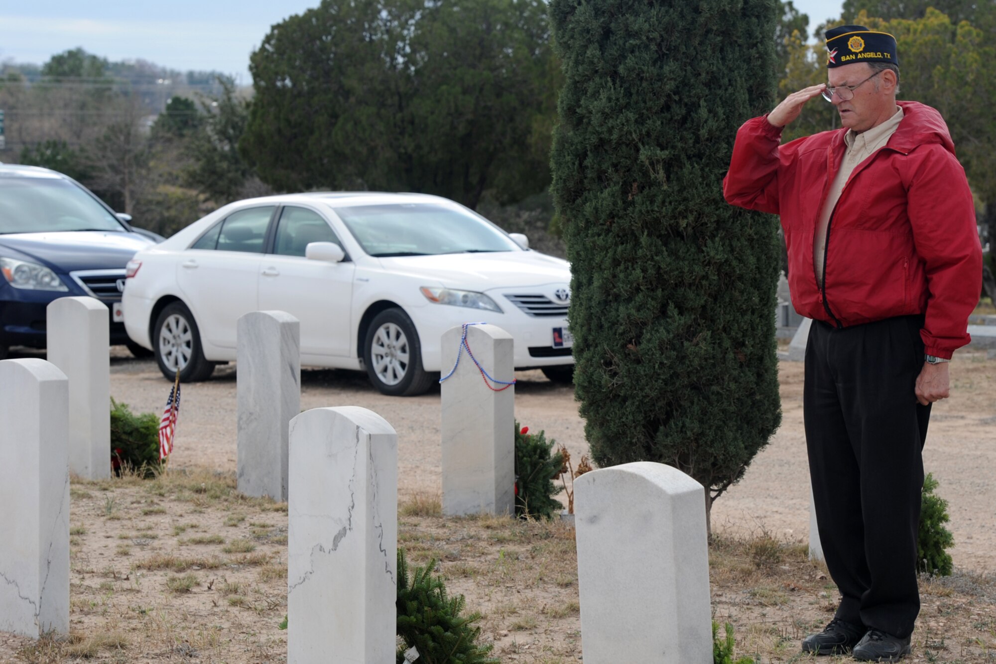 SAN ANGELO, Texas – Retired Master Sgt. Carl C. Frentz, American Legion Post 572 Commander, salutes after placing a wreath at a veteran’s grave during the Wreaths Across America event at Belvedere Cemetery Dec. 13. Wreaths Across America’s mission is Remember, Honor, Teach. (U.S. Air Force photo/ Staff Sgt. Laura R. McFarlane)