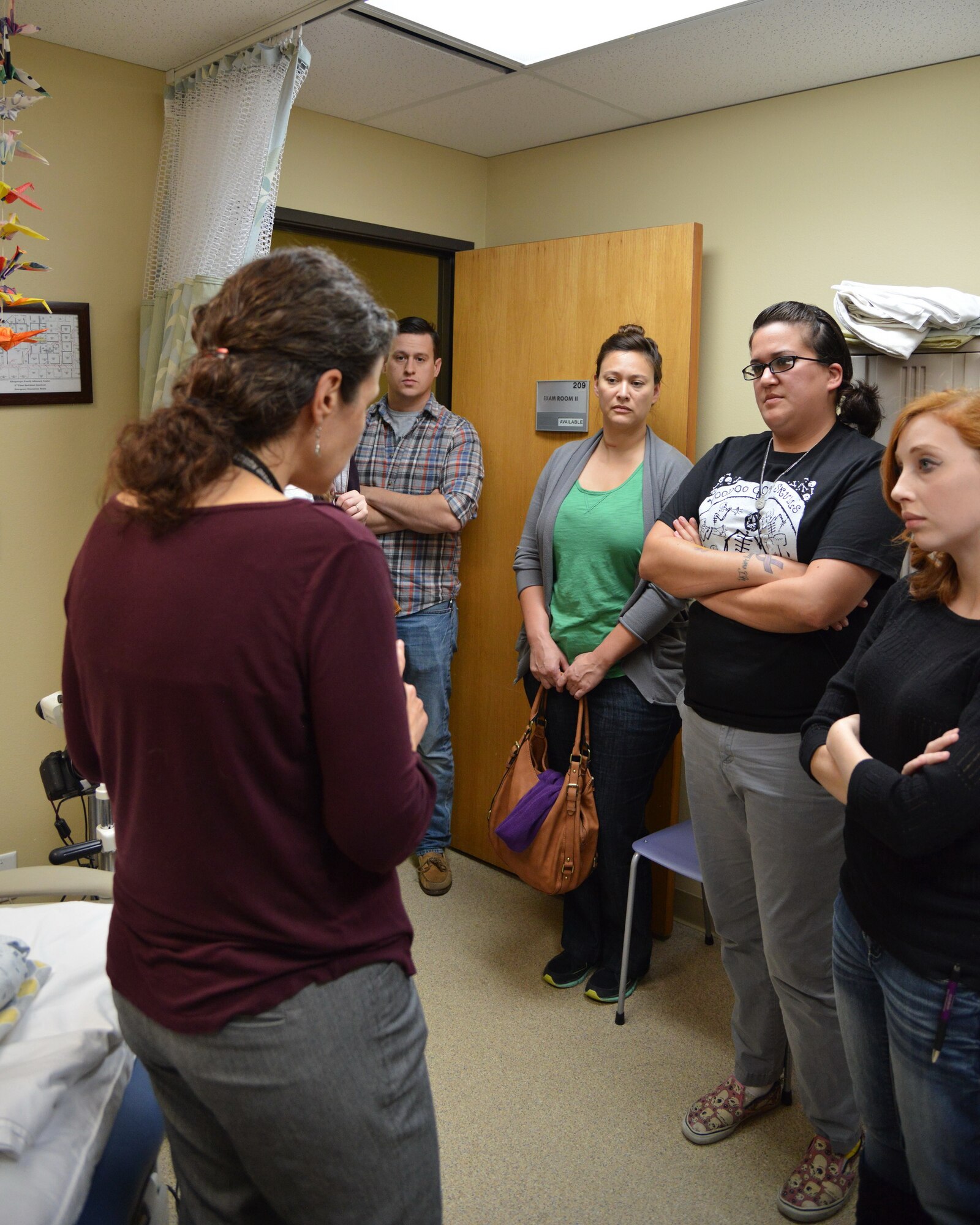 Gail Starr, left, clinical director at the sexual assault nurse examiner's office, gives a tour of the examination room where forensic evidence is gathered. The tour was part of a week-long training session for Kirtland's six new volunteer victim advocates. In the photo, from left to right: Staff Sgt. Cord Tracy, Master Sgt. Zarah Hartsock, Staff Sgt. Brandy Cota, and Staff Sgt. Lauren Shipman. Other victim advocates in training not pictured are Capt. Marti Garrison and Tech. Sgt. Kimesha Mottsmith. (Photo by Jamie Burnett)