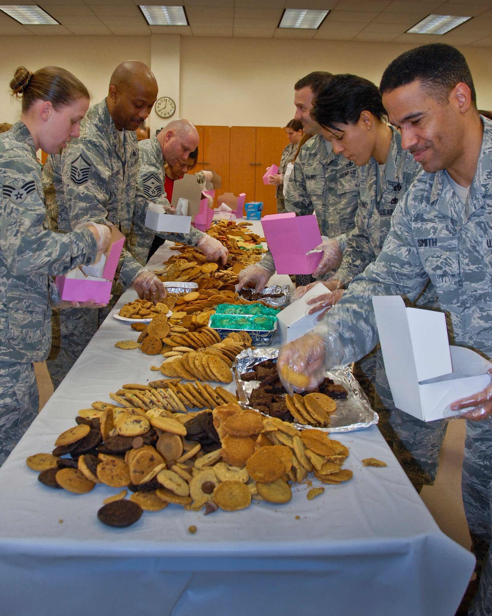 Military and civilian volunteers bag and box cookies for delivery to dorm residents at this year’s “Team Eglin Cookie Caper” at Eglin Air Force Base, Fla. Dec. 16. (U.S. Air Force photo/Kevin Gaddie)


