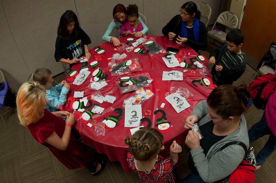 Children and their parents make Christmas ornaments during breakfast with Santa Claus Dec. 13, 2014, at Moody Air Force Base, Ga. In addition to crafting, children watched Christmas movies, enjoyed breakfast and took photos with Santa.
(U.S. Air Force photo by Airman 1st Class Dillian Bamman/Released)
