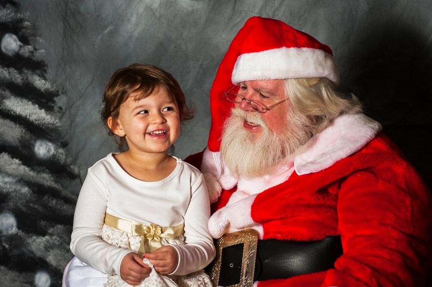 Lillyanne, daughter of U.S. Air Force Tech. Sgt. James Sheppard, NCO in charge of 23d Wing inspection team, sits on Santa Claus’ lap during breakfast with Santa Dec. 13, 2014, at Moody Air Force Base, Ga. Santa after breakfast flew to the 23d Maintenance Group and 347th Rescue Group children’s Christmas party in an HH-60G Pave Hawk. (U.S. Air Force photo by Airman 1st Class Dillian Bamman/Released)