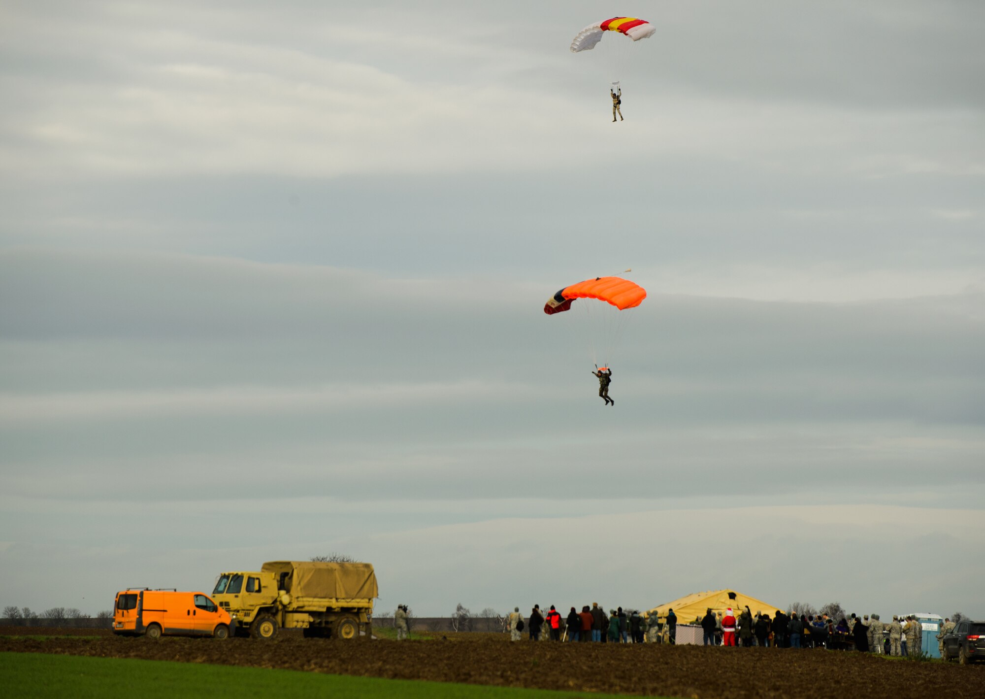 NATO partner paratroopers guide thier parachute during training Dec. 15, 2014 at Alzey Drop Zone, Germany. Airmen, Soldiers and NATO partners participated in a toy drop operation, which was used to train and deliver toys to less fortunate children. (U.S. Air Force photo/Senior Airman Armando A. Schwier-Morales)