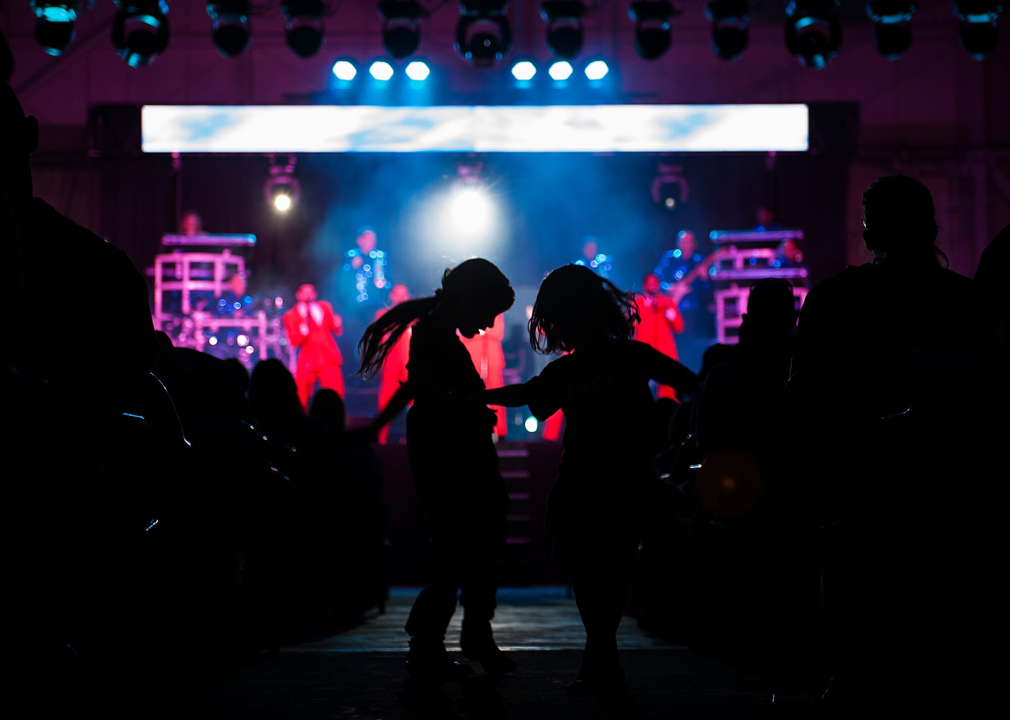 Children dance in the aisle during a Tops In Blue performance Dec. 13, 2014, Incirlik Air Base, Turkey. Tops In Blue is composed entirely of active duty Airmen who travel the globe providing entertainment for service members and their families, coalition partners and other audiences. (U.S. Air Force photo by Senior Airman Krystal Ardrey/Released)