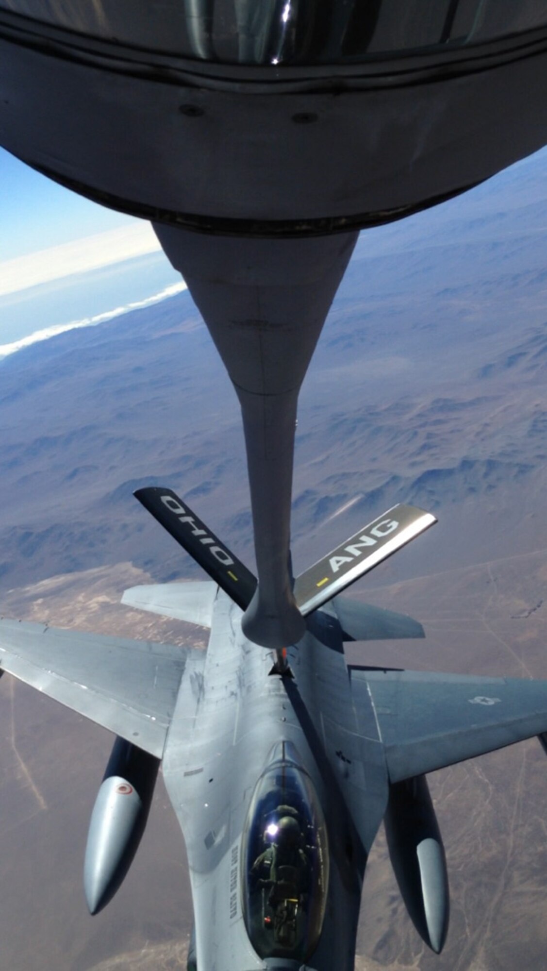 A 121st Air Refueling Wing KC-135 Stratotanker refuels an F-16 Fighting Falcon from the 149th Fighter Wing recently over Chile. The aircraft were taking part in Exercise Salitre. (Photo submitted/Released)