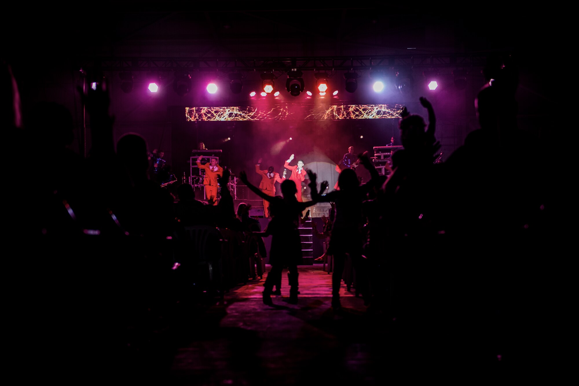 Children dance in the isle during a Tops In Blues show Dec. 13, 2014, at Incirlik Air Base, Turkey. Tops in Blue will perform 86 shows to help boost morale of service members and their families around the world. (U.S. Air Force photo by Airman Cory W. Bush/Released)