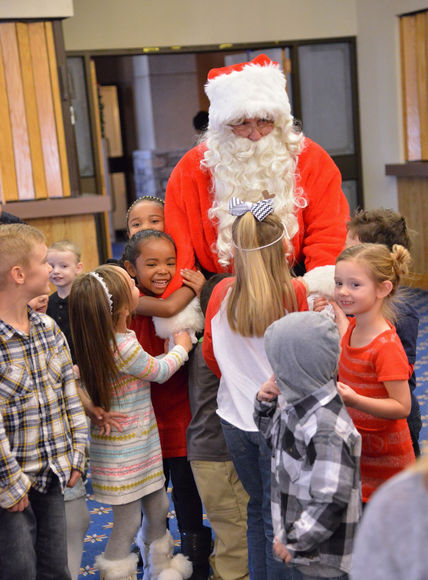 Santa Claus visits with children at the Hearts Apart holiday party Dec. 13 at the Mountain View Club. Hearts Apart is an Airman & Family Readiness Center program for family members who are, will be or have been separated because of military commitments such as deployments, temporary duties or remote tours. (Photo by Jamie Burnett)