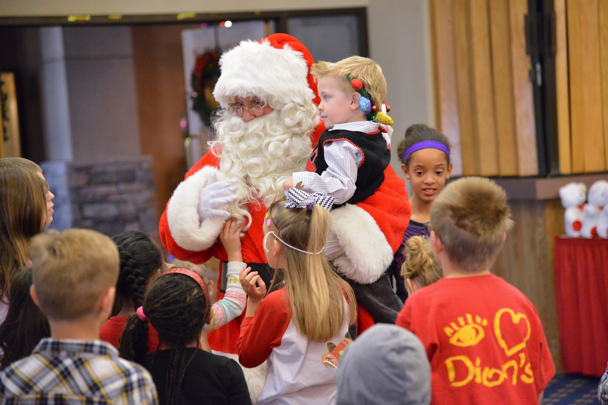 Santa Claus visits with children at the Hearts Apart holiday party Dec. 13 at the Mountain View Club. Hearts Apart is an Airman & Family Readiness Center program for family members who are, will be or have been separated because of military commitments such as deployments, temporary duties or remote tours. (Photo by Jamie Burnett)