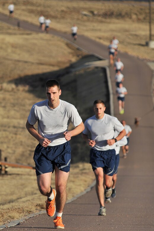 Airmen with the 50th Space Wing participate in the Warfit Run Dec. 10, 2014, at Schriever Air Force Base, Colo. The run was held to honor the following Airmen: Tech. Sgt. Edward Weber, 50th Space Communications Squadron; Capt. Nicholas Goirigolzarri, 50th Operations Group; Airman 1st Class Edward Yu and Airman 1st Class Abtron "Tron" O'Neal, both from 3rd Space Operations Squadron. (U.S. Air Force photo/Dennis Rogers)