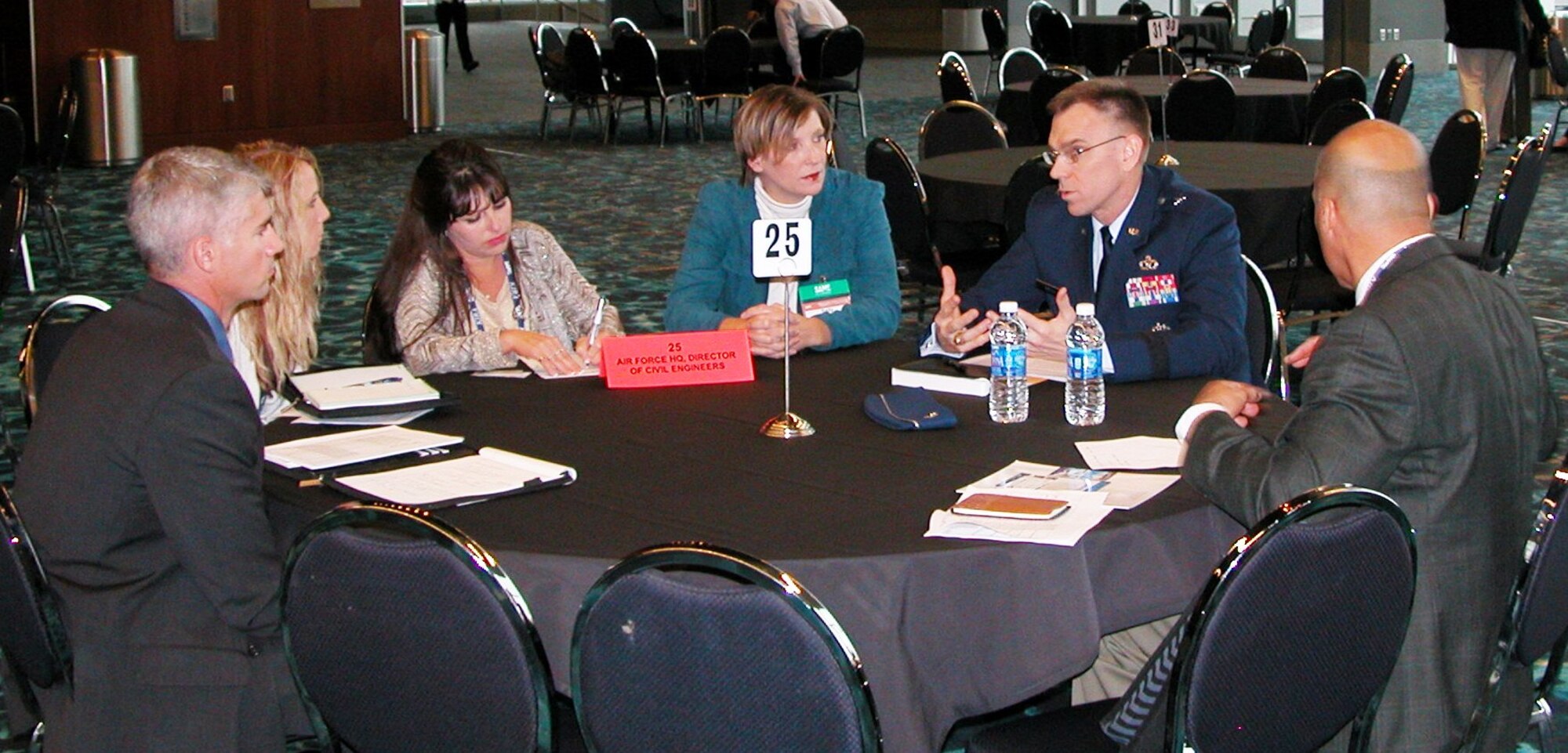 Brig. Gen. Tim Green, Air Force director of civil engineers, and Sally Kite (third from right), chief of the construction flight at the 772nd Enterprise Sourcing Squadron, discuss CE contracting support opportunities with industry representatives during a networking session Dec. 10 at the 2014 Society of American Military Engineers Small Business Conference in Kansas City. (U.S. Air Force photo/Michael Briggs/released)