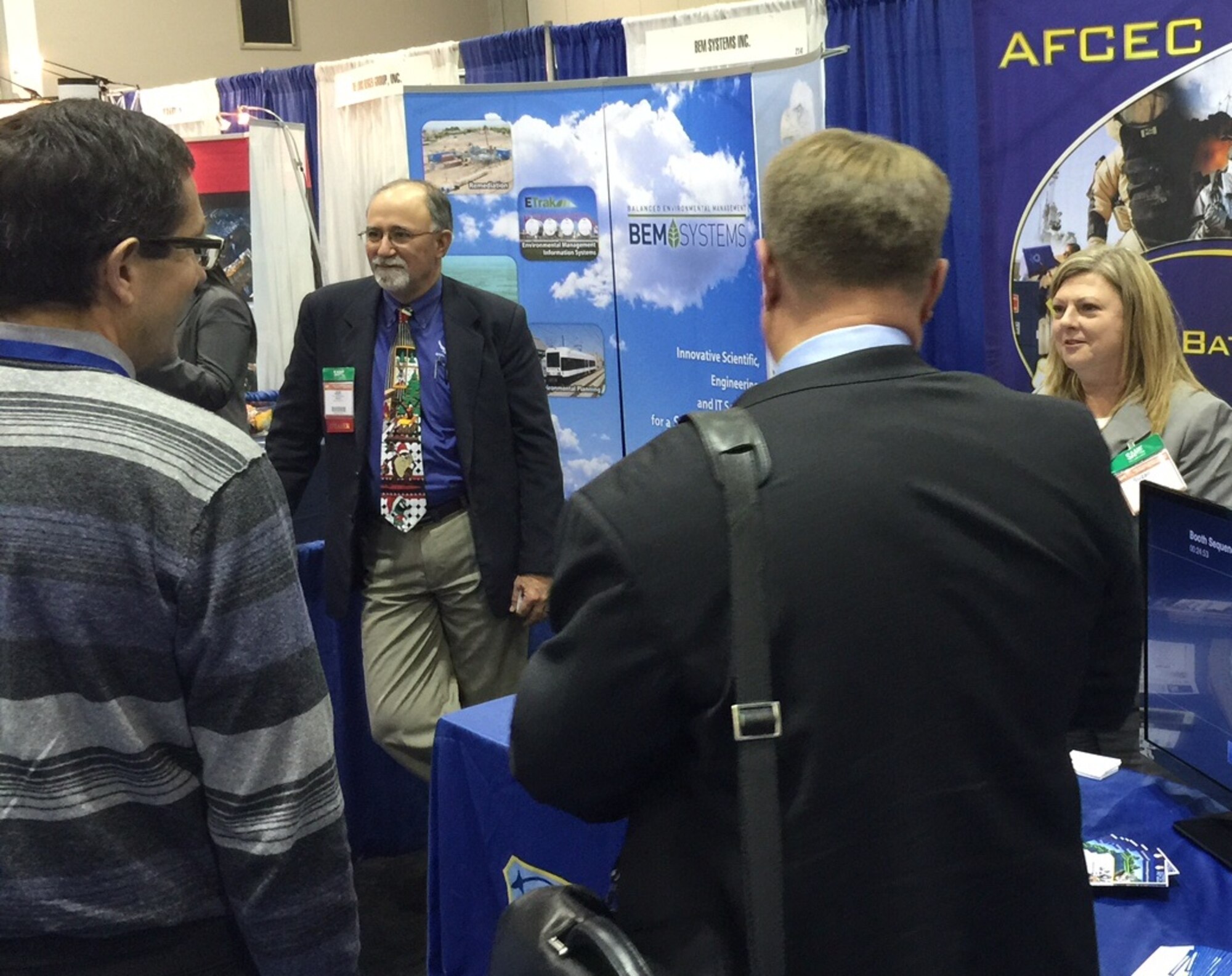Third from right, Joe Sciabica, Air Force Civil Engineer Center director, and Suzanne Bilbrey (right), director of the AFCEC Environmental Directorate, discuss their unit’s operations Dec. 10 at the 2014 Society of American Military Engineers Small Business Conference in Kansas City. (U.S. Air Force photo/Michael Briggs/released)
