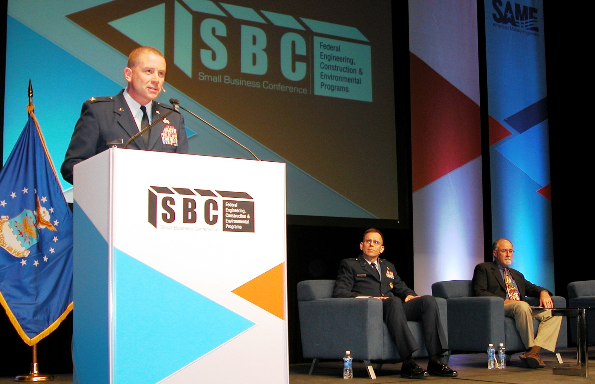 Col. Brian Duffy, Air Force Installation and Mission Support Center vice commander, presents information about his unit to an audience of more than 750 industry representatives at the Air Force general session that kicked off service briefings at the 2014 Society of American Military Engineers Small Business Conference Dec. 9 in Kansas City. (U.S. Air Force photo/Michael Briggs/released)