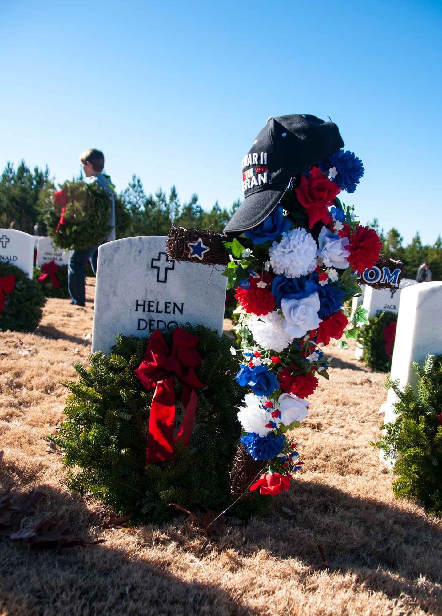 Wreaths lay on gravestones after the Wreaths Across America ceremony at Georgia National Cemetery in Canton, Ga. Dec. 13, 2014. Wreaths Across America occurs the second Saturday of December every year. (U.S. Air Force photo/Senior Airman Daniel Phelps)