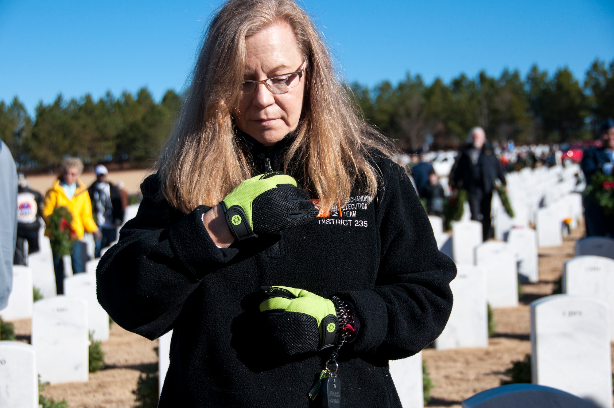 A volunteer pauses for a moment to reflect after laying a wreath at the Wreaths Across America ceremony at Georgia National Cemetery in Canton, Ga. Dec. 13, 2014. Thousands showed up to GNC to honor America’s heroes. (U.S. Air Force photo/Senior Airman Daniel Phelps)