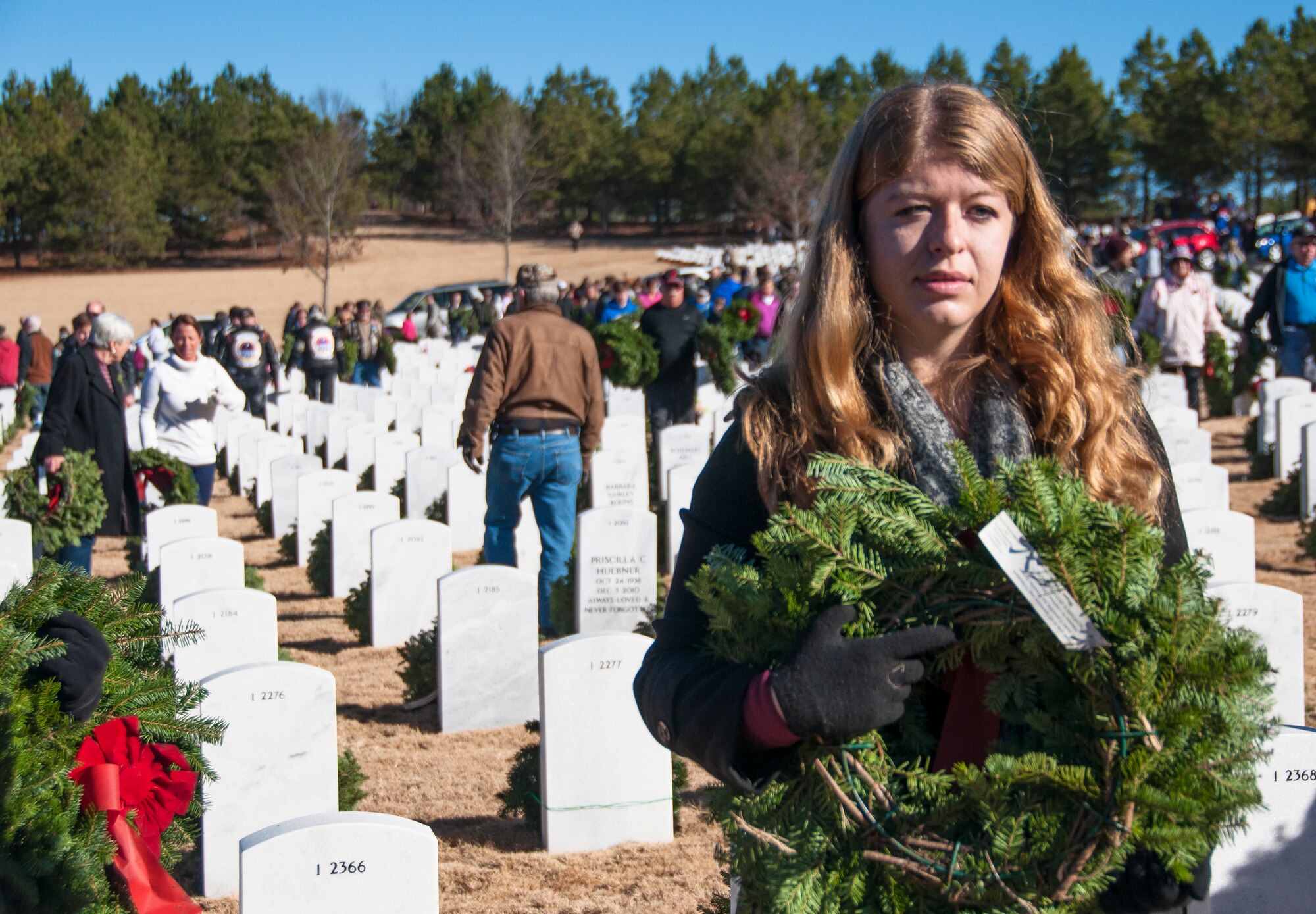 A volunteer prepares to lay a wreath for the Wreaths Across America Ceremony at Georgia National Cemetery in Canton, Ga. Dec. 13, 2014. Thousands showed up to GNC to honor America’s heroes. (U.S. Air Force photo/Senior Airman Daniel Phelps)