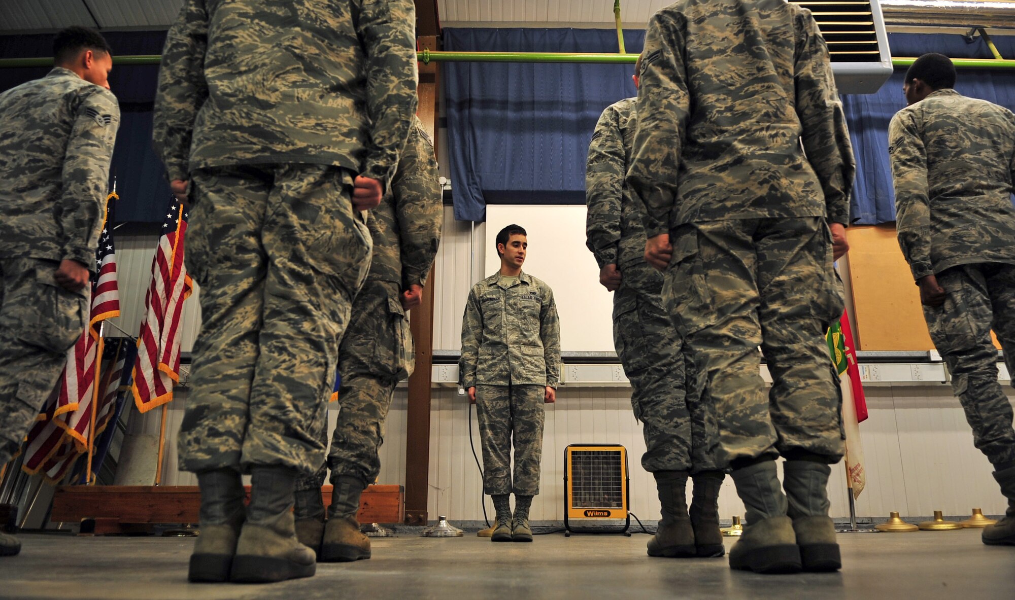 U.S. Air Force Staff Sgt. Aaron Klarenbach, 352nd Special Operations Maintenance Squadron NCO in charge of base honor guard from Vancouver, Wash., educates Airmen interested in joining the honor guard on basic military drill movements Dec. 15, 2014, on RAF Mildenhall, England. The base honor guard is holding a week-long seminar for those interested in joining to help Airmen get a better understanding of what being a honor guard member entails. (U.S. Air Force photo by Senior Airman Christine Griffiths/Released)