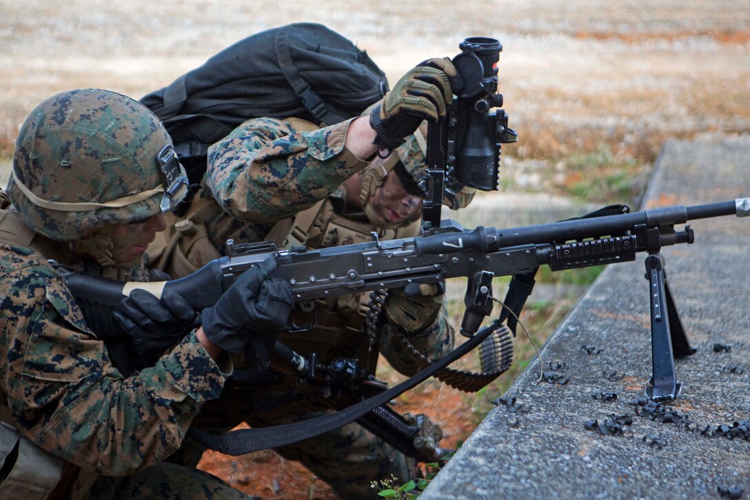 U.S Marines reload an M240 Machine Gun during a vertical assault at Combat Town, Okinawa, Japan, Dec. 10, 2014.