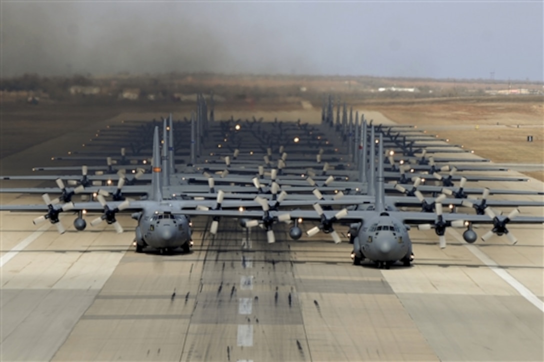 C-130H Hercules and and C-130J Super Hercules aircraft prepare to take off from Dyess Air Force Base, Texas in support of the U.S. Air Force Weapons School's Joint Forcible Entry Exercise 14B in Nev., Dec. 6, 2014. The Hercules crews are assigned to National Guard units, and the 317th Airlift Group at Dyess Air Force Base, Texas. In addition to the C-130s, the JFEX included approximately 20 C-17 Globemaster IIIs and various other aircraft.