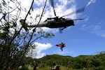 California Air National pararescuemen  begin extraction to a hovering HH60-G Pave Hawk rescue helicopter, Marine Corps Training Area Bellows, Waimanalo, Hawaii, April 28, 2014. The objective for the Guardian Angel Team assigned to the 129th Rescue Wing, Moffett Federal Airfield, California., was the recovery of civilian personnel from a downed aircraft. The wing saved a man at sea on Dec. 15, 2014.