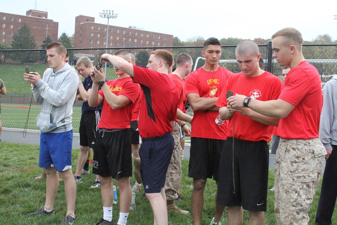 Candidates from Marine Corps Officer Selection Team Cincinnati conduct land navigation training during a pool function at the University of Dayton, Oct. 25, 2014. The pool function consisted of a 45-minute physical training session where the group of approximately 40 Marines and applicants completed a run around campus and land navigation training. (U.S. Marine Corps photo by Sgt. Jennifer Pirante)
