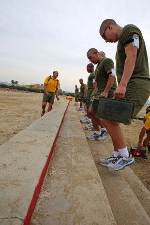 Recruits of Echo Company, 2nd Recruit Training Battalion, perform weighted step-ups at Marine Corps Recruit Depot San Diego, Dec. 11. Each ammunition can weighed approximately 30 pounds.