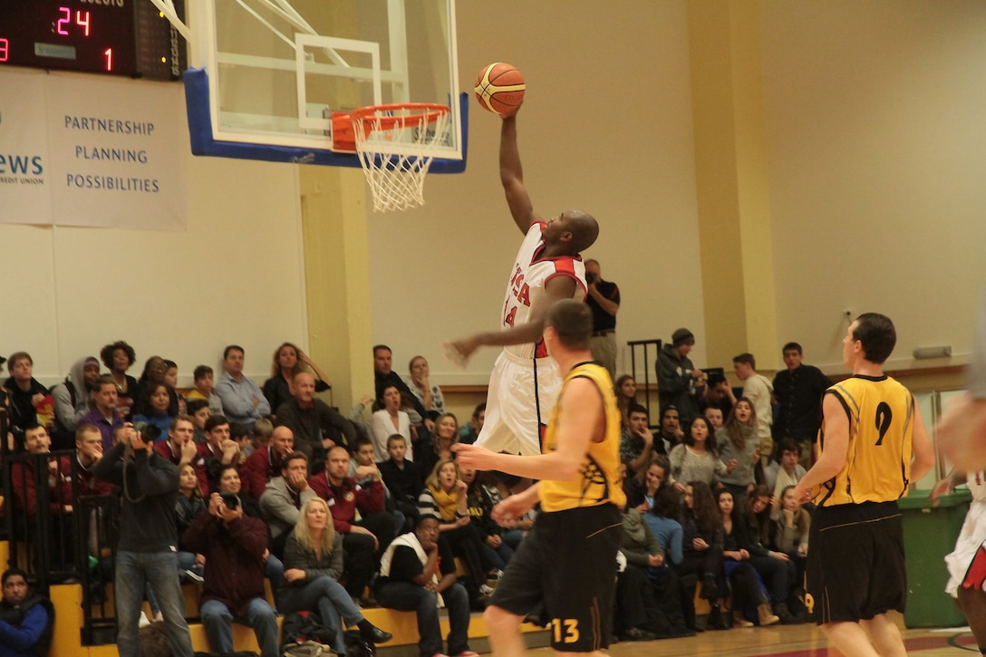 Air Force 2nd lt. Mike Lyons of Peterson Air Force Base, Colo., dunks the ball during USA's 89-82 victory over Lithuania in the championship game of the 2014 SHAPE International Basketball Championship Dec. 1-6. Photo courtesy of Patrick Ferriol, pfphotography.be