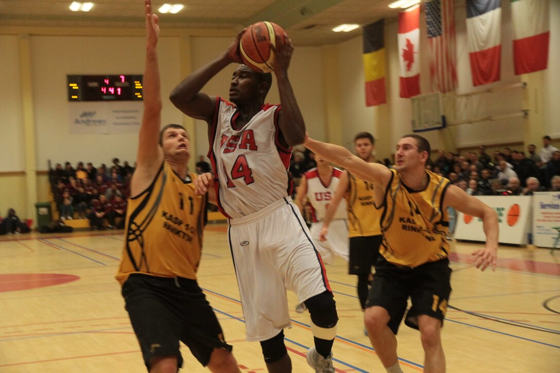 Air Force 2nd lt. Mike Lyons of Peterson Air Force Base, Colo., drives in for the lay-up during USA's victory over Lithuania 89-82 at the SHAPE International Basketball Championship Dec. 1-6 2014. Photo courtesy of Patrick Ferriol, pfphotography.be