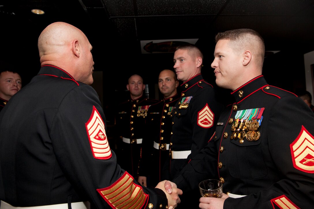 17th Sgt. Maj. of the Marine Corps, Sgt. Maj. Micheal P. Barrett talks with Marines during the reception of Mess Night hosted by the Camp Lejeune Staff Non Commissioned Officer Academy Career Course Class 1-15, aboard Marine Corps Air Station New River, N.C., Dec 4, 2014. Sgt. Maj. Barrett was the guest of honor for the ceremony. (U.S. Marine Corps photo by Cpl. Michael C. Guinto / Released)