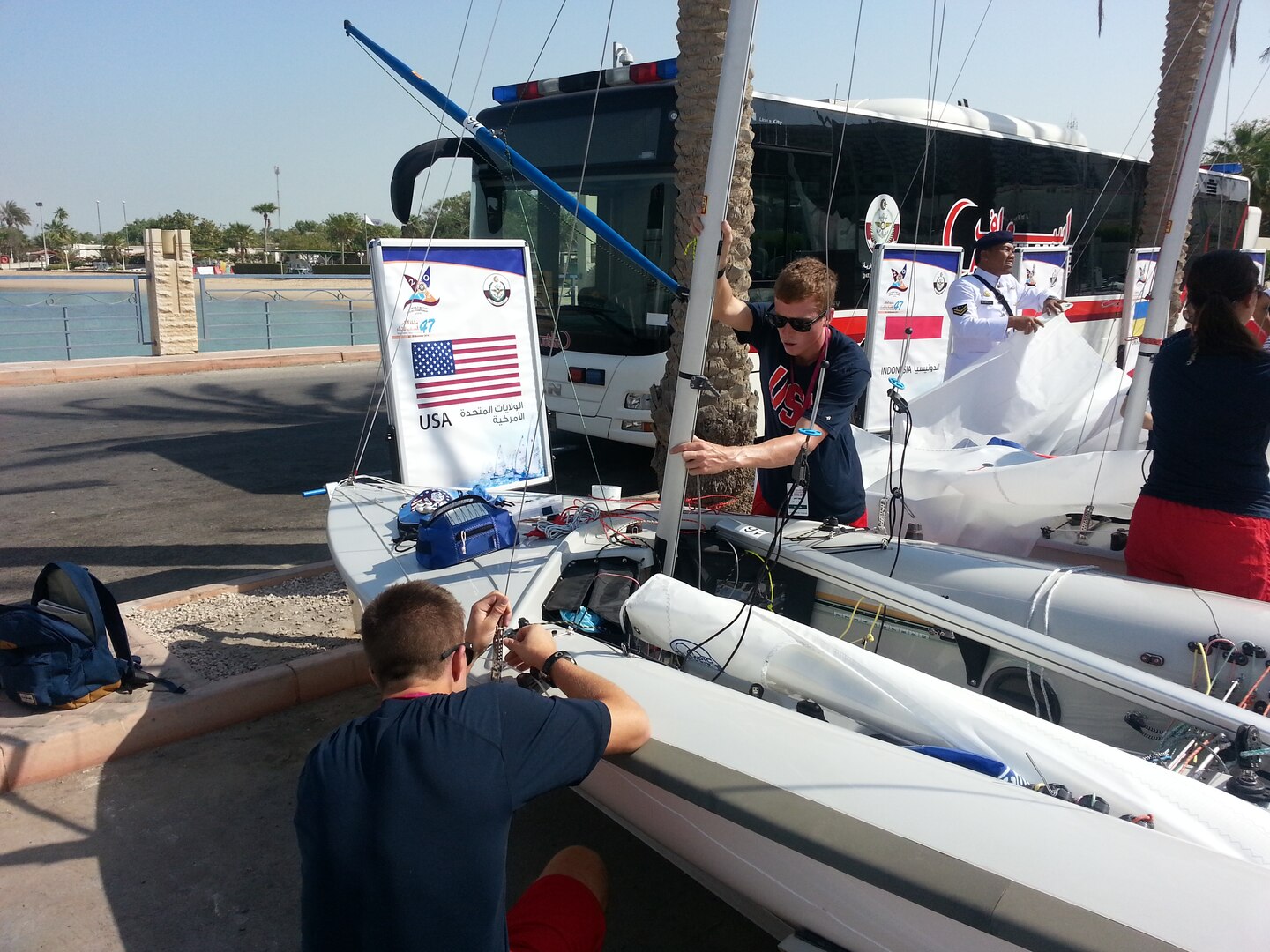 Men’s skipper Coast Guard Lt. j.g. Samuel Ingham of Naval Air Station Pensacola, Fla. and Coast Guard Lt. j.g. Sean Kelly of San Francisco Sector, Calif. prepare their vessel prior to the 47th CISM World Military Sailing Championship held in Doha, Qatar Nov. 22-29, 2015.