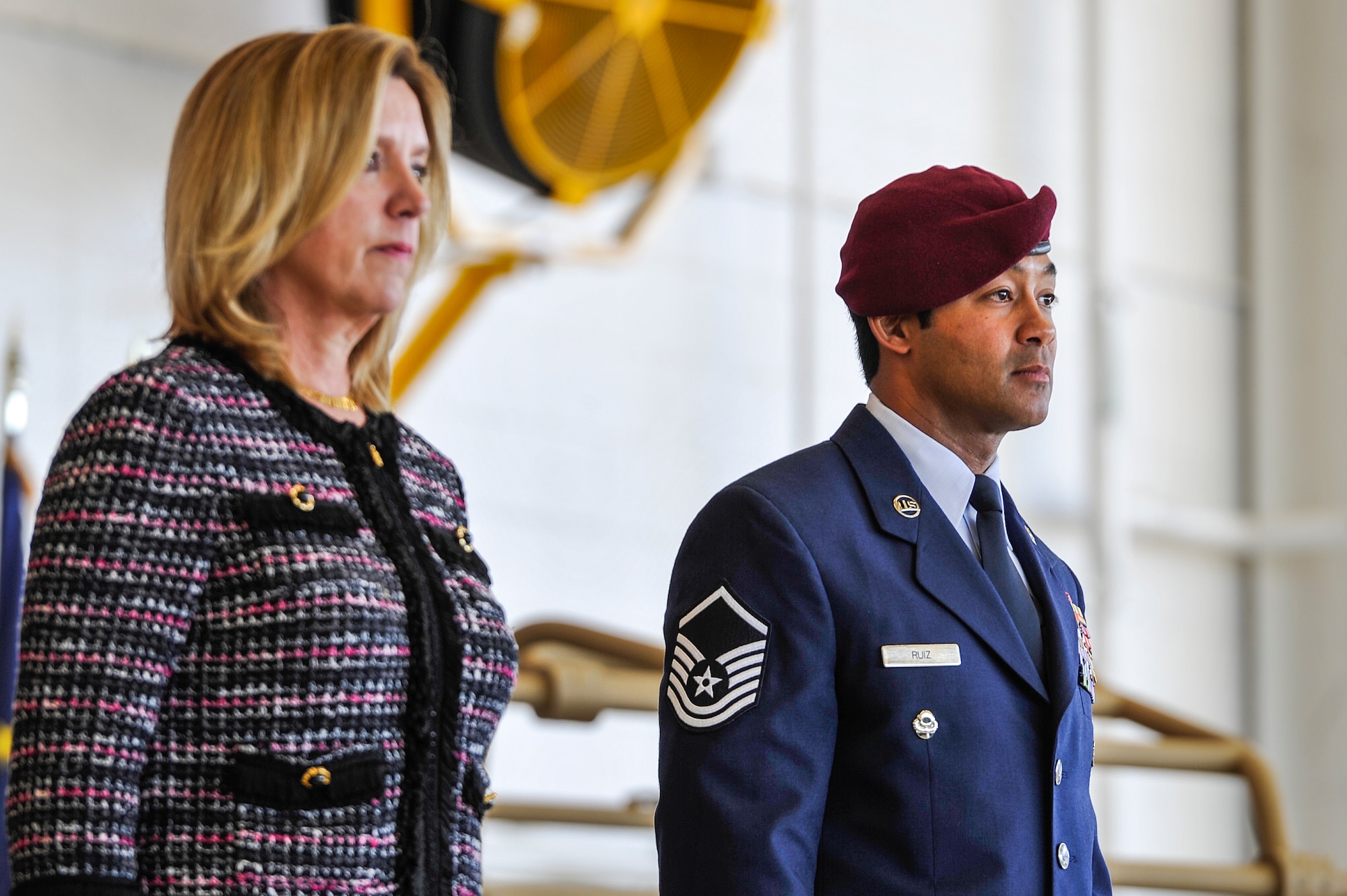Secretary of the Air Force Deborah Lee James and Master Sgt. Ivan Ruiz, a pararescueman from the 56th Rescue Squadron, Royal Air Force Lakenheath, England, listen to the award citation during an Air Force Cross ceremony at the Freedom Hangar on Hurlburt Field, Fla., Dec. 17, 2014. During a 2013 deployment to Afghanistan, Ruiz protected injured special operations forces with fire support and provided emergency medical care under intense enemy fire in the dark, directly resulting in two U.S. lives saved. The last six Air Force Crosses have all been awarded to AFSOC Special Tactics Airmen.  (U.S. Air Force photo/Airman 1st Class Jeff Parkinson)