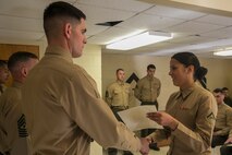 Lance Cpl. Monica Rodriguez (right), a motor vehicle operator with Combat Logistics Battalion 2, Combat Logistics Regiment 2 and a native of Philadelphia, receives her graduation certificate after completing the Lance Corporal Leadership and Professional Ethics Seminar aboard Marine Corps Base Camp Lejeune, N.C., Dec. 12, 2014. The seminar was constructed around group discussions in small classes and focused on focus the Marine Corps’ mission to maintain readiness, create leaders and build ethical citizens both in and out of uniform.