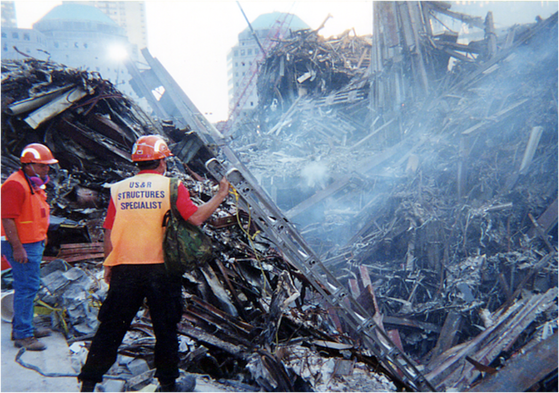 Tom Niedernhofer, wearing the structures specialist vest, stands at Ground Zero during recovery efforts at the fallen World Trade Center, New York City, in 2001. Niedernhofer is the U.S. Army Corps of Engineers urban search and rescue program manager.