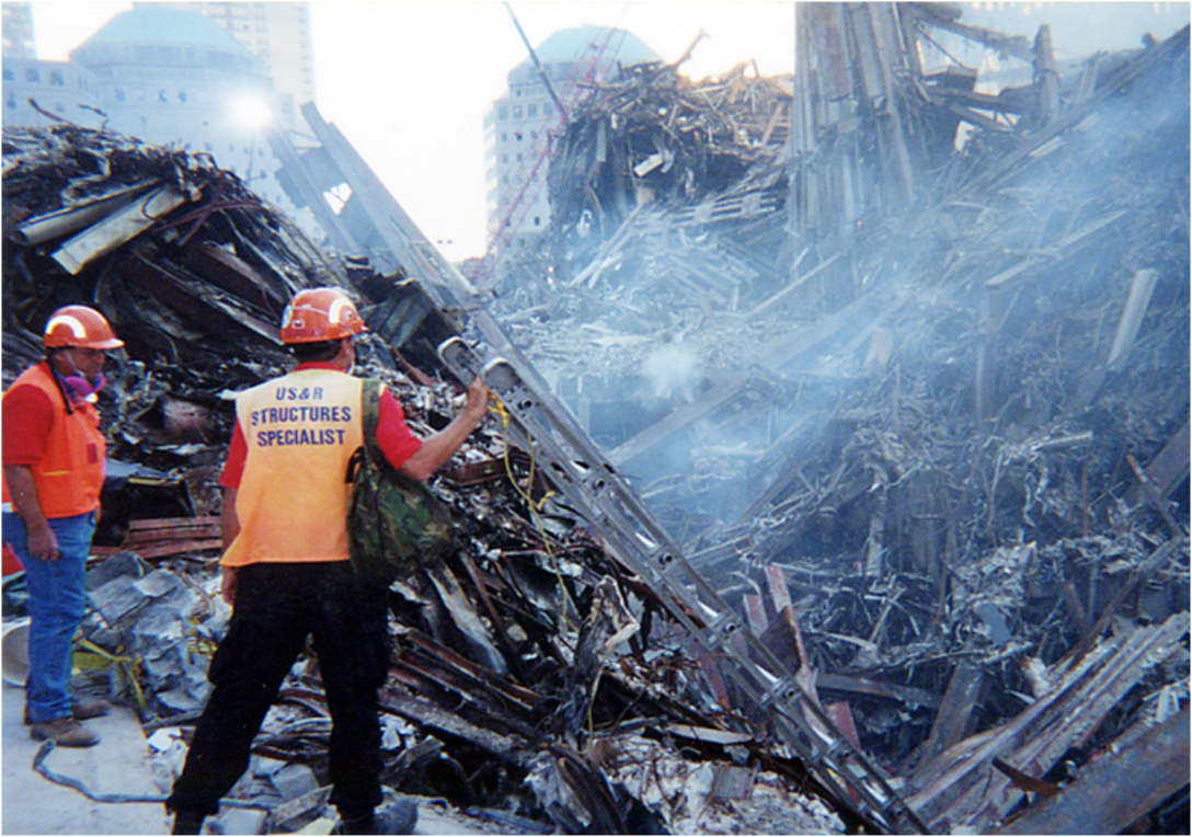 Tom Niedernhofer, wearing the structures specialist vest, stands at Ground Zero during recovery efforts at the fallen World Trade Center, New York City, in 2001. Niedernhofer is the U.S. Army Corps of Engineers urban search and rescue program manager.