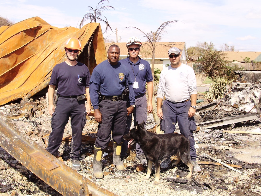 Rescue team members including Jeff Qunell,U.S. Army Corps of Engineers, far left, in Galveston, Texas, September 2008, pausing during post-Hurricane Ike assessment efforts. 