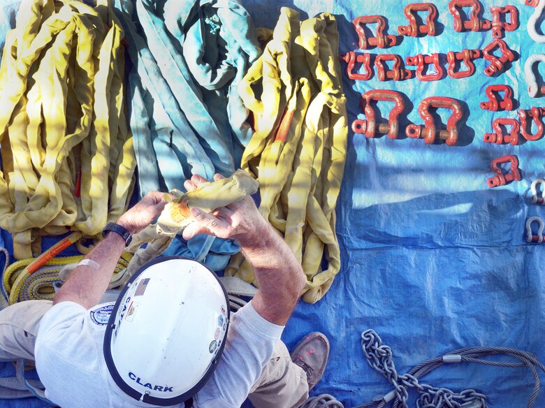 An instructor explains the basic elements of rigging a load to be safely lifted by a crane during rescue training at Moffett Field, California, Oct. 29, 2014. Rescue engineers must understand how to quickly assess and guide the removal of crumbled structural elements in the aftermath of a disaster.