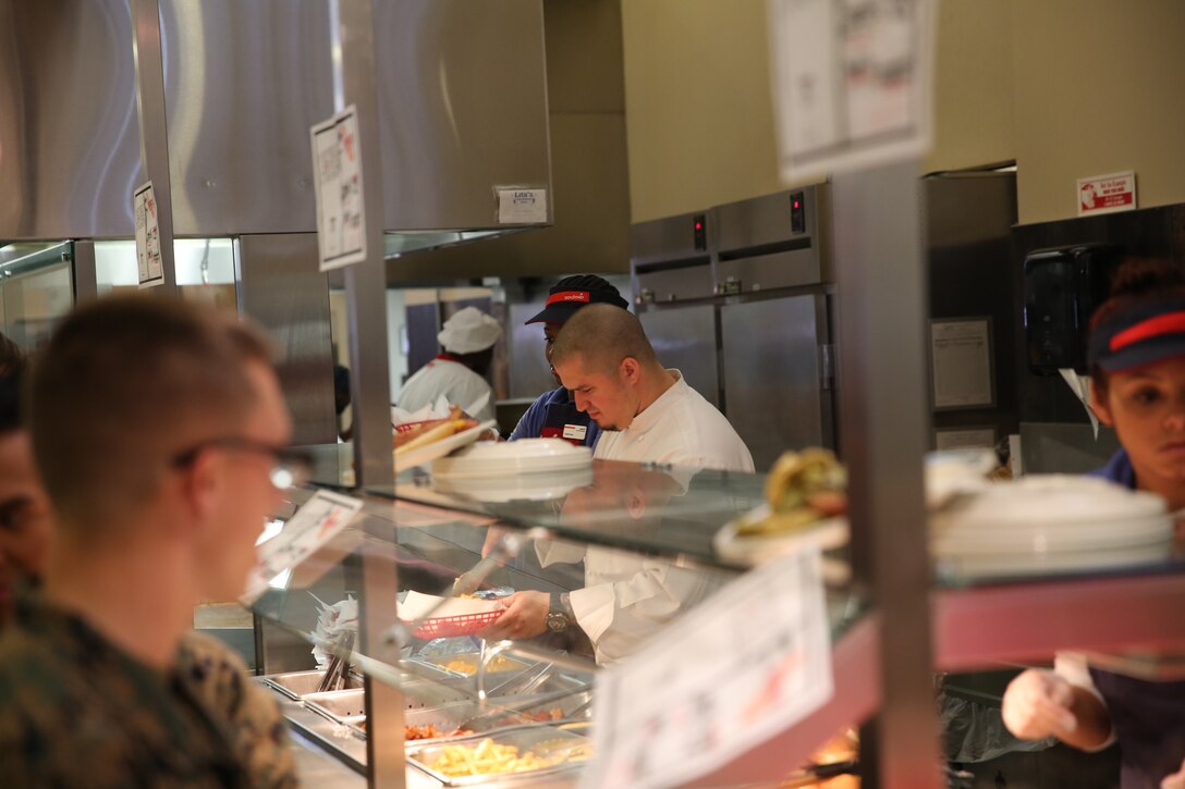 George Kapetsonis, Pink’s franchisee, prepares a specialty at Littleton mess hall, Dec. 2, 2014. This is the first of many events that Sodexo hopes to hold with outside food vendors. (Official Marine Corps photo by Lance Cpl. Medina Ayala-Lo/Released)