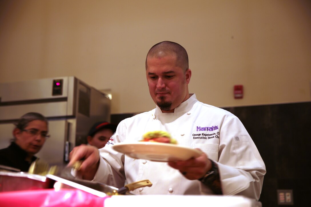 George Kapetsonis, Pink’s franchisee, prepares a gourmet hot dog at Littleton mess hall, Dec. 2, 2014. Sodexo plans to bring in civilian chefs periodically to share techniques with food service specialists. (Official Marine Corps photo by Lance Cpl. Medina Ayala-Lo)