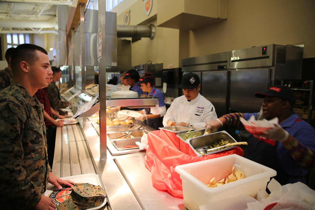 George Kapetsonis, Pink’s franchisee, prepares a specialty hot dog at Littleton mess hall, Dec. 2, 2014. Sodexo is planning to host the next outside food vendor event at Phelps hall in March. (Official Marine Corps photo by Lance Cpl. Medina Ayala-Lo/Released)