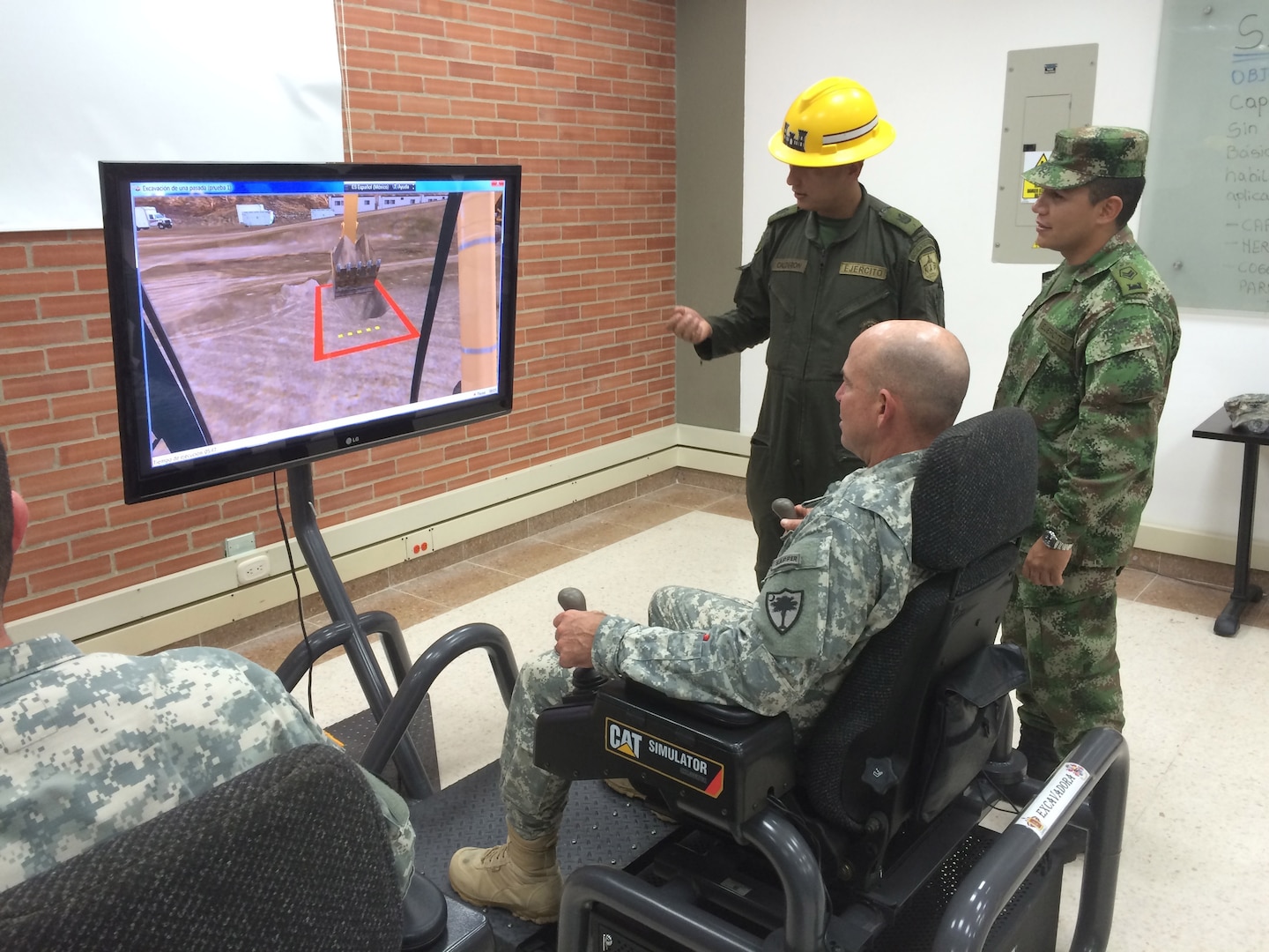 Col. Brad Owens, South Carolina National Guard director of plans, training and operations, uses an engineering simulator while on a monthlong state partnership engagement between the S.C. National Guard and members of the Colombian Army in Colombia, November 2014. The South Carolina National Guard established a formal state partnership with Colombia in 2012 and has conducted multiple engagements to share ideas to assist the Colombian Army with equipment maintenance programs.