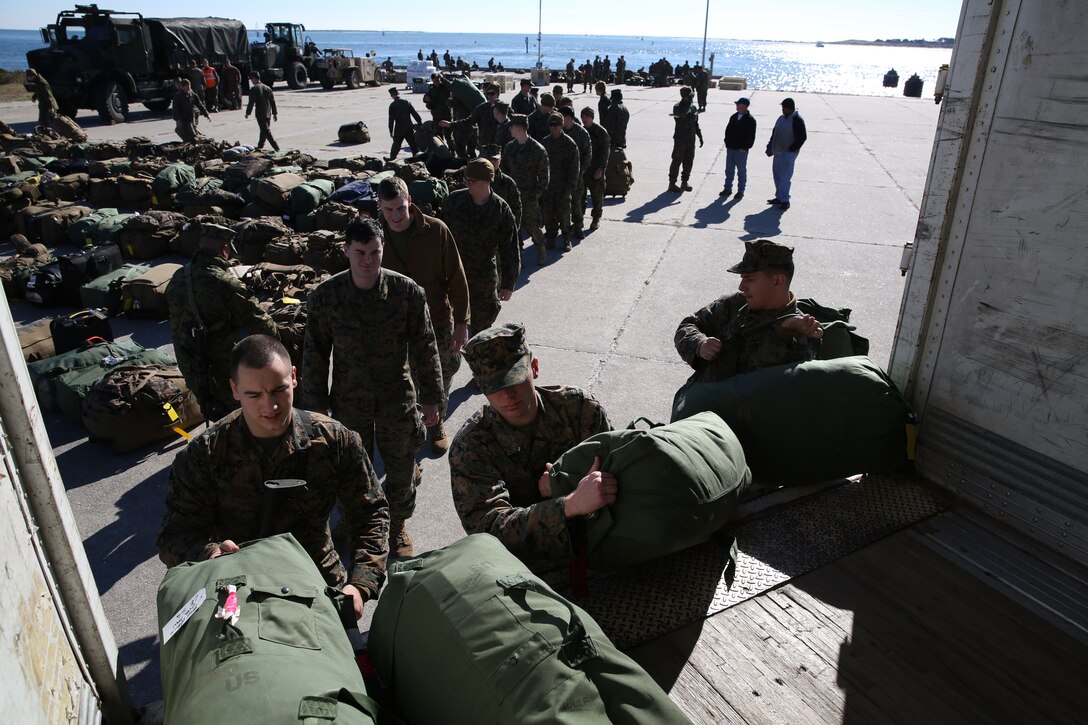 Marines with the 24th Marine Expeditionary Unit unload sea bags in Morehead City, N.C., Dec. 13, 2014. Marines staged equipment prior to embarking on the ships of the Iwo Jima Amphibious Ready Group for their 2015 deployment. The 24th MEU is scheduled to support operations in the 5th and 6th Fleet areas of responsibility.