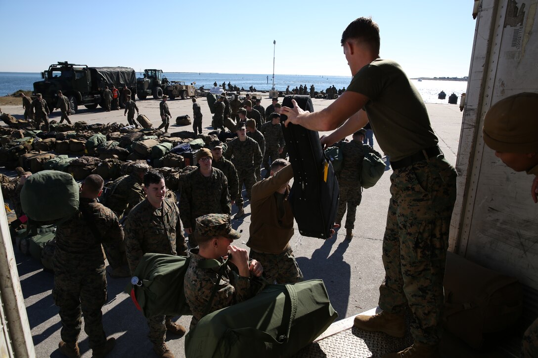 A Marine with the 24th Marine Expeditionary Unit unloads sea bags in Morehead City, N.C., Dec. 13. Marines staged equipment prior to embarking on the ships of the Iwo Jima Amphibious Ready Group for their 2015 deployment. The 24th MEU is scheduled to support operations in the 5th and 6th Fleet areas of responsibility.