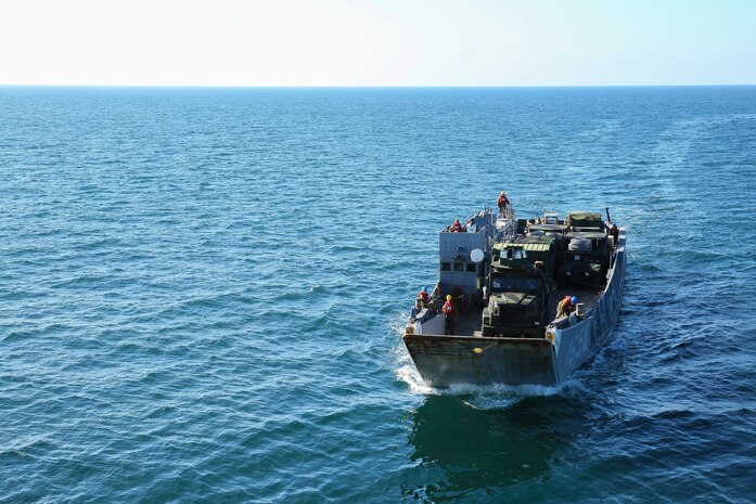 A Navy Landing Craft, Utility, or LCU, transports vehicles with the 24th Marine Expeditionary Unit to the USS Iwo Jima, Dec. 14, 2014. The 24th MEU embarked on the ships of the Iwo Jima Amphibious Ready Group for their 2015 deployment Dec. 12-14. The 24th MEU is scheduled to support operations in the 5th and 6th Fleet areas of responsibility.