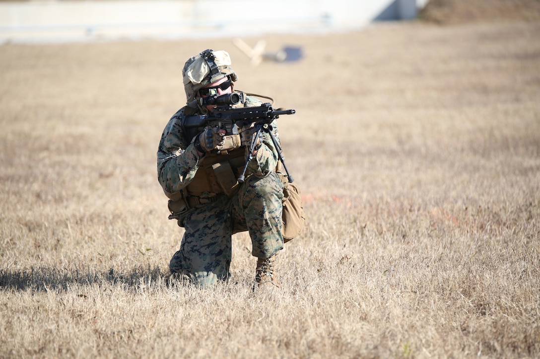 Lance Cpl. Max D. Tackett, rifleman, Company A, Ground Combat Element Integrated Task Force, executes an assault on a simulated enemy position during a fire team collective skills exercise at Range K509, Marine Corps Base Camp Lejeune, North Carolina, Dec. 16, 2014. The Marines utilized the M4 carbine rifle and M16-A4 service rifle, as well as the M27 Infantry Automatic Rifle and M203 grenade launcher. From October 2014 to July 2015, the Ground Combat Element Integrated Task Force will conduct individual and collective skills training in designated combat arms occupational specialties in order to facilitate the standards based assessment of the physical performance of Marines in a simulated operating environment performing specific ground combat arms tasks. (U.S. Marine Corps photo by Cpl. Paul S. Martinez/Released)